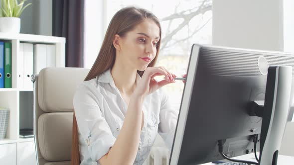 Young Woman Works at Home Office Using Computer.