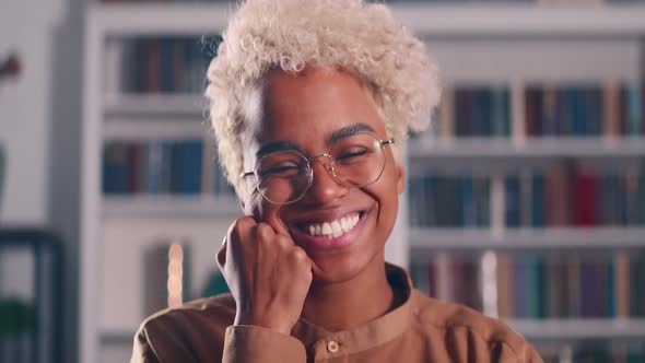 African American Millennial Woman Smile Look at Camera Stand Indoor Alone