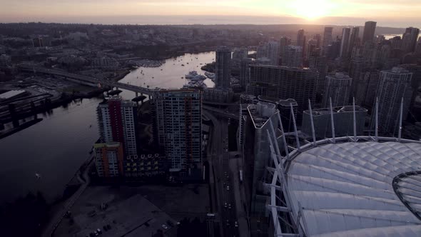 Drone flying over BC Place with bridge on False Creek at sunset, Vancouver, British Columbia in Cana