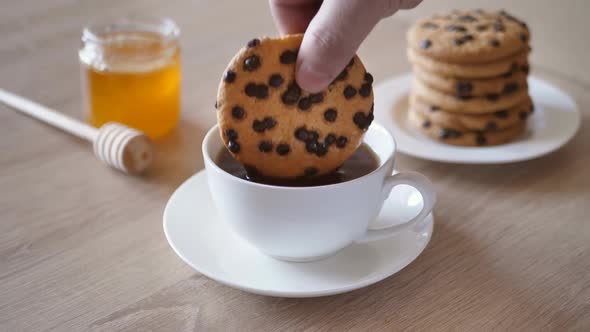 Hand Dipping Chocolate Chip Cookies in Coffee