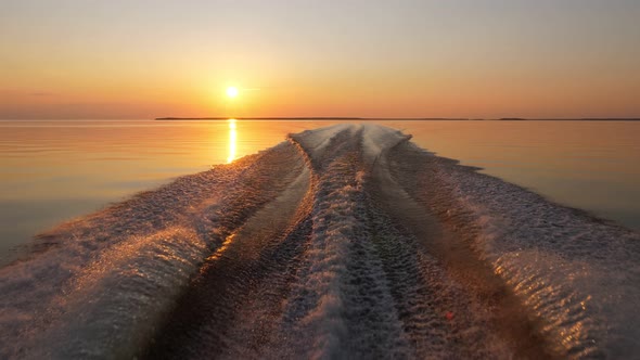 Beautiful view from running boat, saturated sunset and calm lake