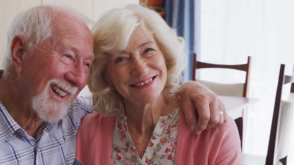 Senior couple in social distancing smiling at camera