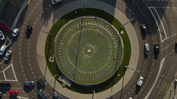 Top Down Aerial View Roundabout Traffic With Circular Fountain on Sunny Day