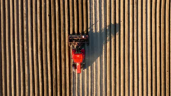 Aerial View of Tractor Performs Seeding on the Field