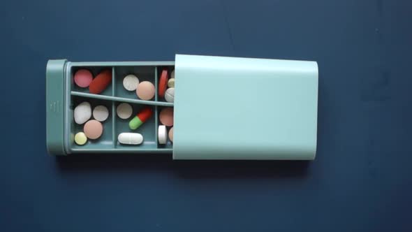 Close Up of Medical Pills in a Pill Box on Table