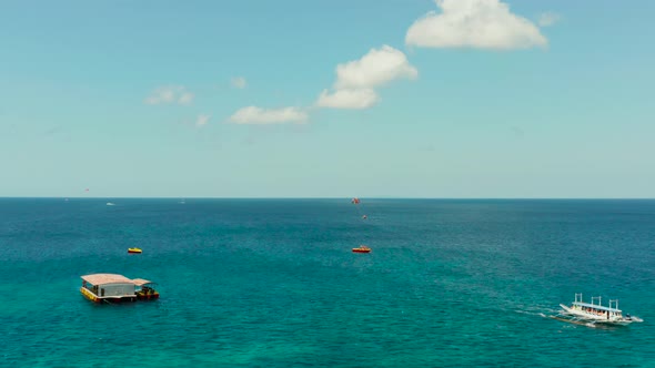 Tourists on a Parachute Over the Sea. Boracay, Philippines