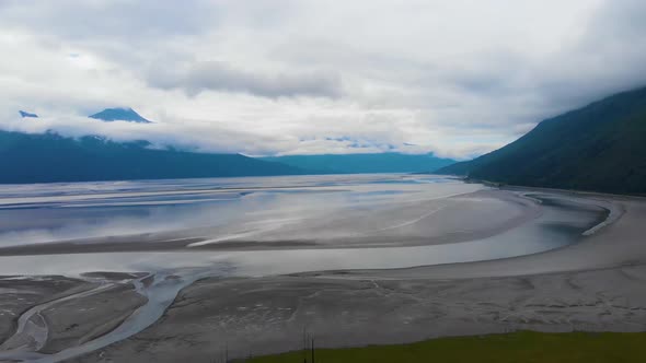 4K Cinematic Drone Video (dolly back) of Mountains Overlooking Turnagain Arm Bay at Low Tide Near An