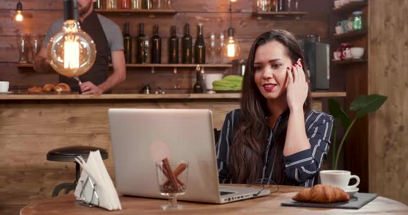 Beautiful Woman Listens To Her Favorite Song While Working on Her Laptop