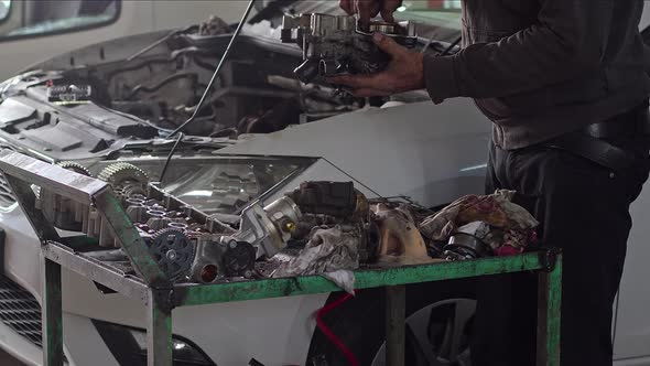 Mechanic Checking Car's Defective Turbocharger At Car Repair Shop 2