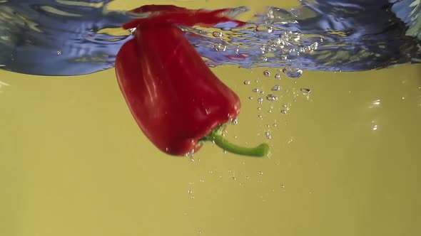 Paprika Splashing Into Water in Slowmotion