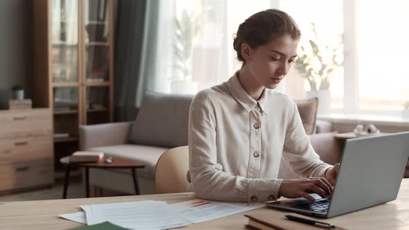 Woman Working with Laptop at Home