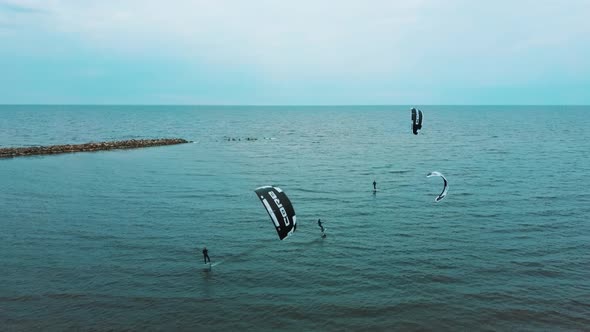 Aerial Drone View of a Corekites Kitesurfers Hydrofoiling  in Engure Port at in Baltic Sea