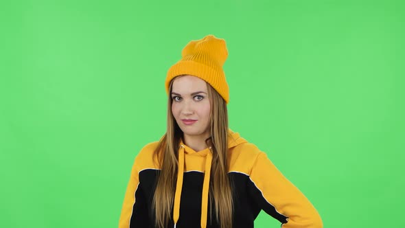 Portrait Modern Girl in Yellow Hat Is Seductively Smiling and Gesture Threatens By Shaking Her Index