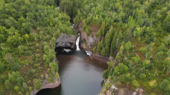 Beautiful waterfall in North Minnesota by lake superior shoreline during summer time