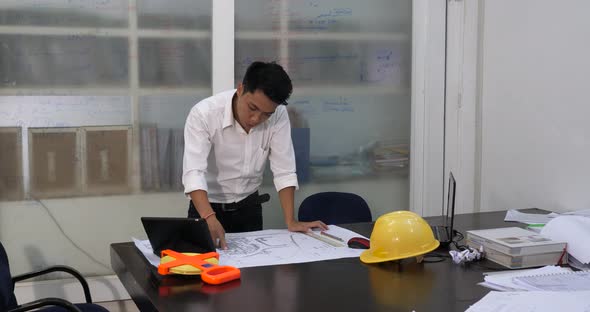 Male Engineer Looking At Blueprint