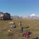 Aerial Shot of a Group of Tourists with Backpacks Climb the Mountain - VideoHive Item for Sale