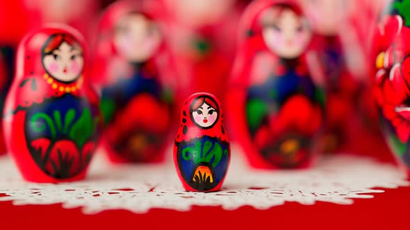 The little one handmade matryoshka doll. Babushkas placed on a white doily.