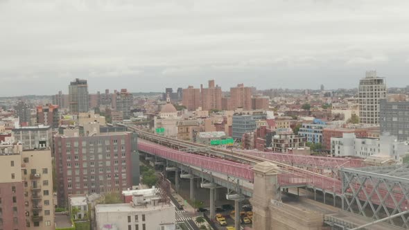 AERIAL: Flight Over Williamsburg Bridge Brooklyn Side with Car Traffic and Streets at Cloudy Day 