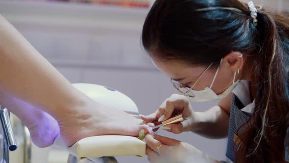 Cosmetologist Performs the Procedure Makes Brush Strokes Applies Varnish Processes the Client's Nail