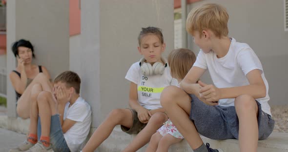 Mother of Many Children Sitting Near Home Babysitting During the Holidays