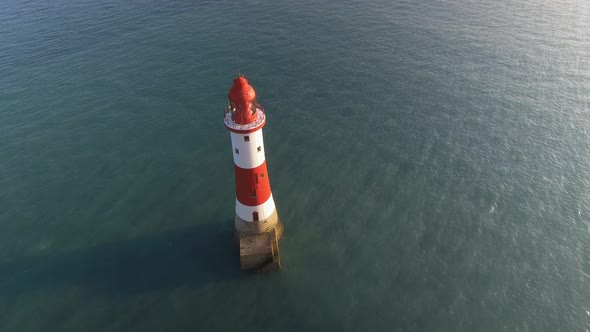 Lighthouse in the Sea at Sunset