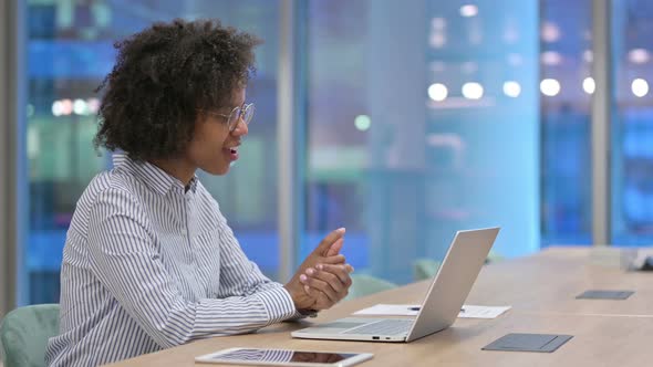 Happy African Businesswoman Doing Video Call on Laptop in Office 