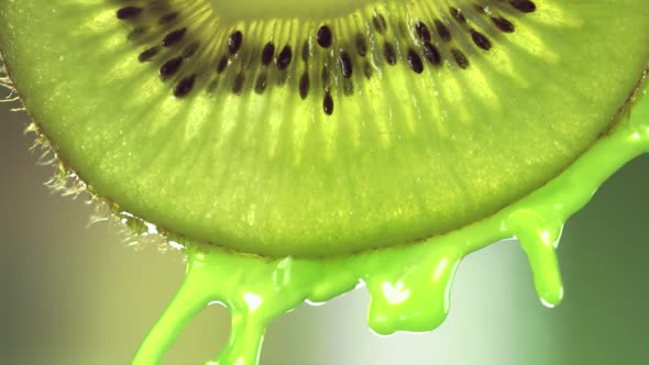 Super Slow Motion Macro Shot of Flowing Juice From Kiwi Slice at 1000Fps