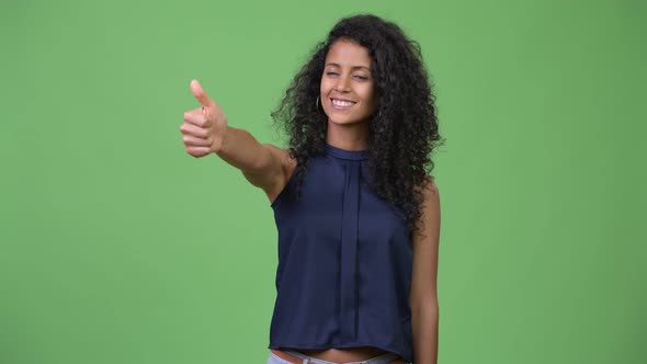 Young Beautiful Hispanic Businesswoman Giving Thumbs Up