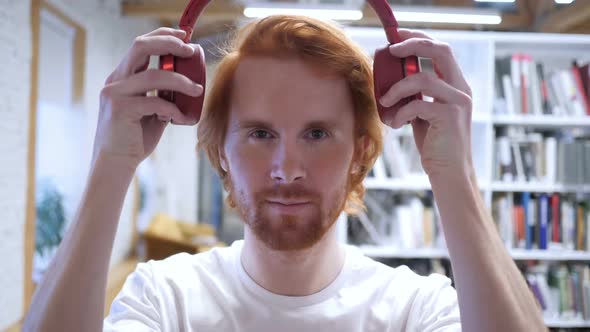 Young Man Wearing Headphones to Listen Music