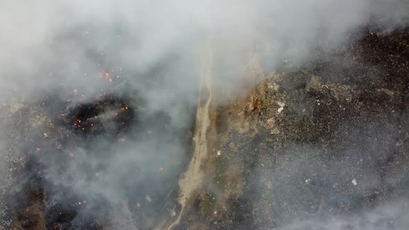 Aerial view half left of garbage dump site is burn by fire