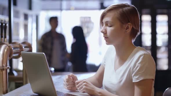 Woman at Bar Counter Talking on Video Call