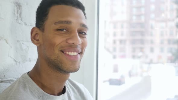 Close Up of AfroAmerican Young Man Smiling to Camera