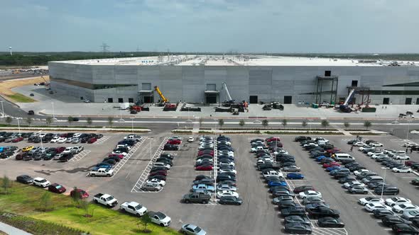 Huge Giga Texas building under construction. Employee parking at location in June 2022. Aerial view
