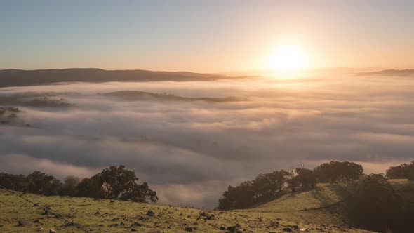 Morning Picturesque Sunrise With Clouds and Fog Moving In Valley Below, Victoria, Australia
