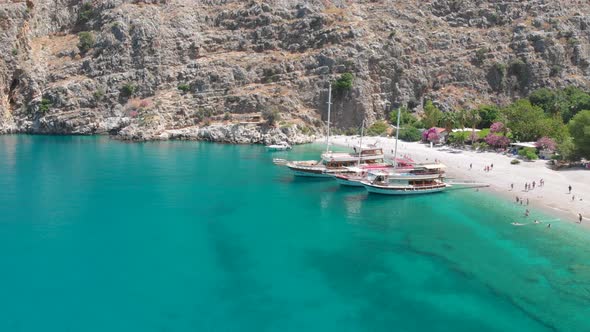 4k Aerial view of Butterfly valley beach and boats, Yacht stationed on the beach in Fethiye Turkey,