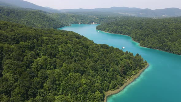 View from above of the Plitvice Lakes National Park with many green plants and beautiful lakes, dron