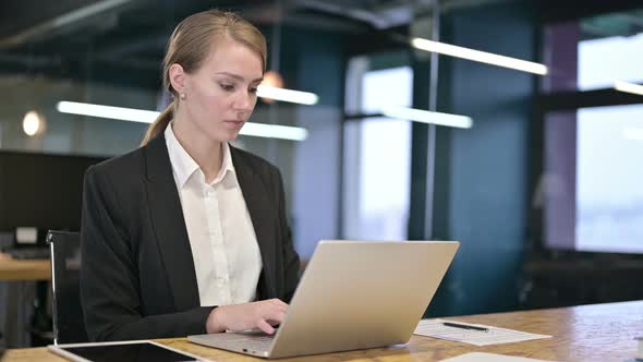 Attractive Young Businesswoman Standing Up and Going Away