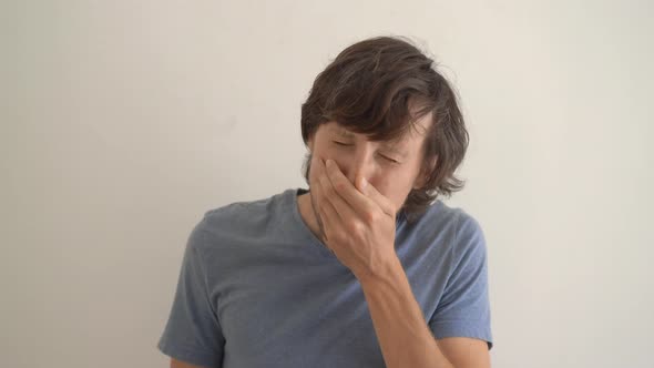 A Young Man Sneezes Improperly