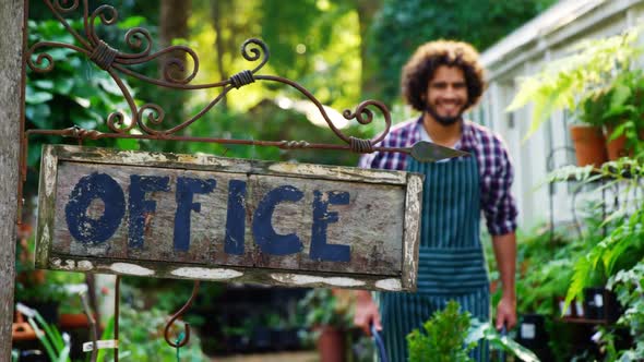 Gardener walking near office signboard