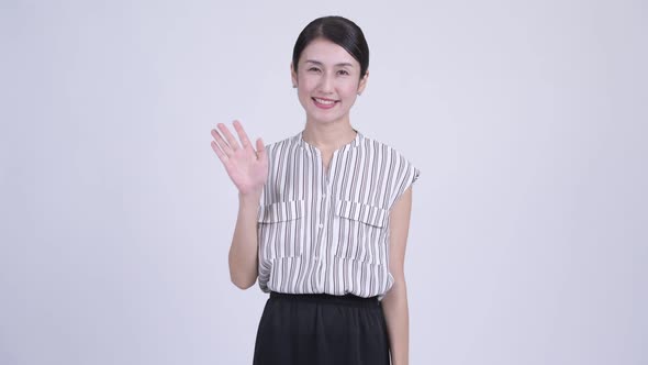 Happy Beautiful Asian Businesswoman Waving Hand