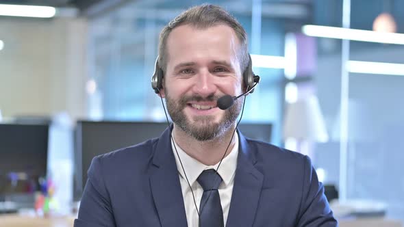 Portrait of Young Businessman Smiling with Headset