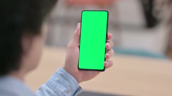 Rear View Man Using Smartphone with Green Chroma Key Screen