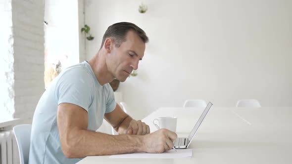 Pensive Man Working in Office Paperwork