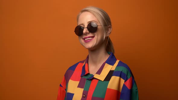 Style blonde in 90s shirt smiling in to camera