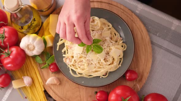 Making Pasta Carbonara  Pouring Fresh Basil to Parmesan Cheese Spaghetti Ceramic Dish