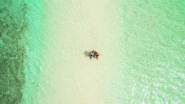 Happy Couple, Man and Woman Stand in Shallow Water in the Turquoise Water of Snake Island in El Nido