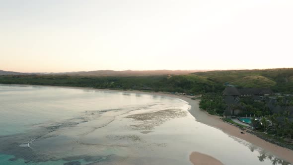 Stunning scenery of a tropical lagoon in Fiji during sunrise, aerial footage