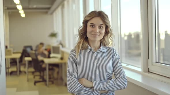 Confident Woman Standing in Office Gives Kind Friendly Look at Camera Smiles Irrl