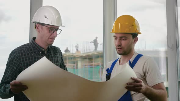 Engineer and Worker in Uniform Are Happy with Successful Construction Project and Work Plan alt