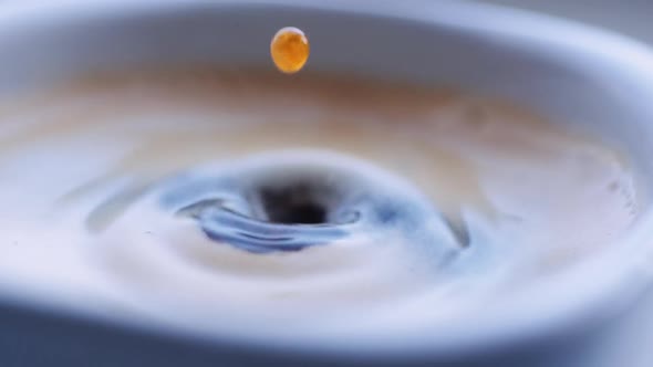Drop of Coffee Falls Into the Filled Cup